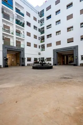 a large white building with a large courtyard at Casa Lilas Free Parking & Gym & Optical Fiber Oldtown 5 mn Walk in Rabat