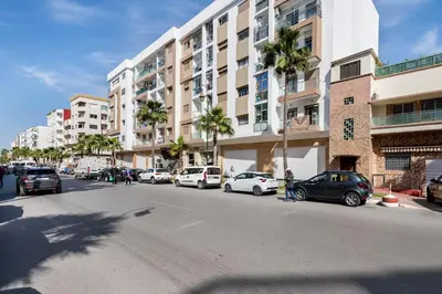 a city street with cars parked in front of a building at Casa Lilas Free Parking & Gym & Optical Fiber Oldtown 5 mn Walk in Rabat