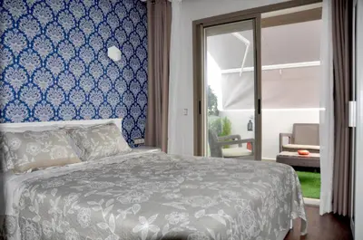 a bedroom with a bed with a blue wall at Casa Lilas Free Parking & Gym & Optical Fiber Oldtown 5 mn Walk in Rabat