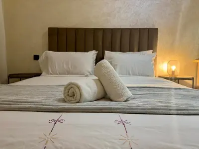 a bedroom with a bed with towels on it at Casablanca Central Suites - Casa Port in Casablanca