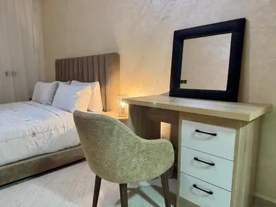 a bedroom with a desk with a mirror and a chair at Casablanca Central Suites - Casa Port in Casablanca