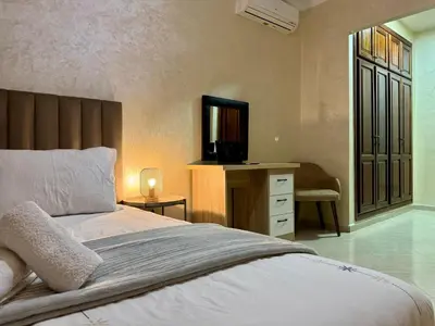 a bedroom with a bed and a desk with a television at Casablanca Central Suites - Casa Port in Casablanca