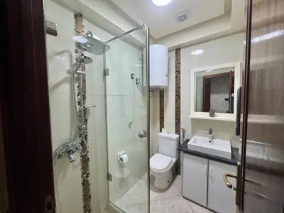 a bathroom with a shower and a toilet and a sink at Casablanca Central Suites - Casa Port in Casablanca