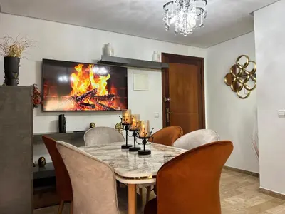 a dining room with a table and a fireplace at Charmant Appart Moderne au Cœur de Rabat avec Fibre in Rabat
