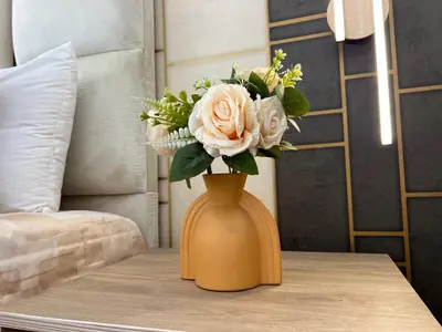 a vase with a bouquet of flowers on a table at Charmant Appart Moderne au Cœur de Rabat avec Fibre in Rabat