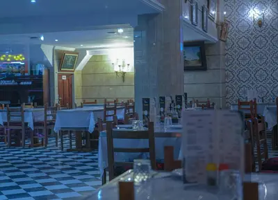 a dining room with tables and chairs in a restaurant at Appart-Hôtel BEL ANFA in Casablanca
