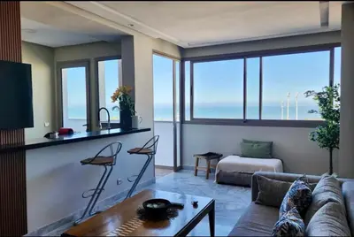 a living room with a couch and a table at Luxurious Sea View 2 Bedroom Apartment in Anfa