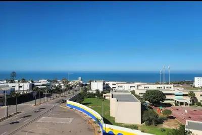 a view of a street with the ocean in the background at Luxurious Sea View 2 Bedroom Apartment in Anfa
