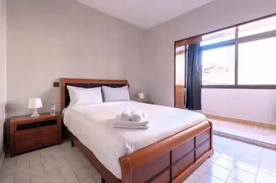 a bedroom with a bed with two towels on it at Appartement Cosy à Maarif, à Côté du McDonald's in Casablanca