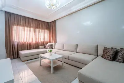 a living room with a couch and a table at Appartement Cosy à Maarif, à Côté du McDonald's in Casablanca