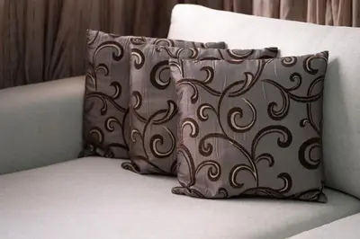 a brown pillow sitting on top of a couch at Appartement Cosy à Maarif, à Côté du McDonald's in Casablanca