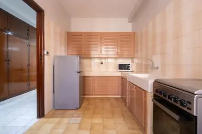 a kitchen with a refrigerator and a sink at Appartement Cosy à Maarif, à Côté du McDonald's in Casablanca