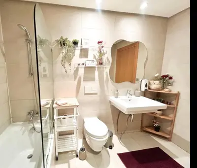 a bathroom with a toilet and a sink and a shower at Beach Front Apartement With Pool in Casablanca