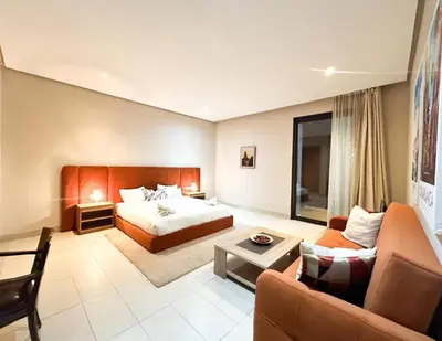 a hotel room with a bed and a couch at Beach Front Apartement With Pool in Casablanca