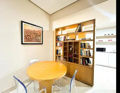 a dining room with a wooden table and chairs at Beach Front Apartement With Pool in Casablanca