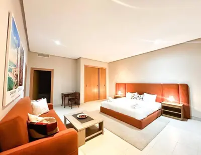 a hotel room with a bed and a couch at Beach Front Apartement With Pool in Casablanca