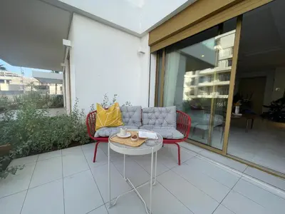 a patio with a couch and a table at Charmant studio avec vue sur mer in Rabat