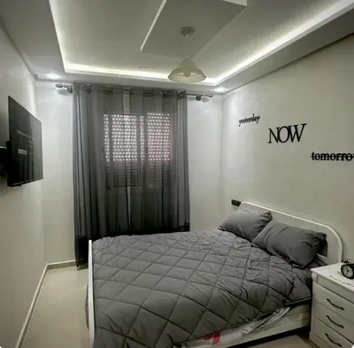 a bedroom with a bed with anow sign on the wall at Surf appart Darb in Casablanca