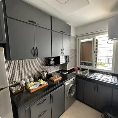 a kitchen with a sink and a washing machine at Surf appart Darb in Casablanca