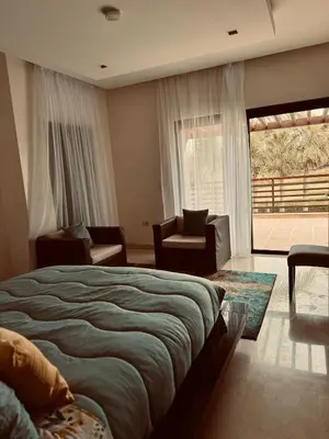 a bedroom with a bed and a large window at Mazagan private villa in El Jadida