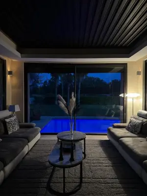 a living room with a couch and a table with a vase at Mazagan private villa in El Jadida