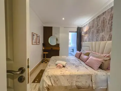 a bedroom with a large bed with pink pillows at AnfaSuites Casablanca - Les princesses - Cocon Urbain in Casablanca
