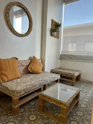 a living room with a couch and a table and a mirror at AnfaSuites Casablanca - Les princesses - Cocon Urbain in Casablanca
