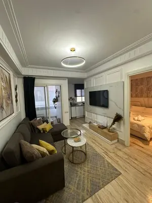 a living room with a couch and a tv at AnfaSuites Casablanca - Les princesses - Cocon Urbain in Casablanca