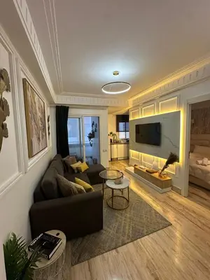 a living room with a couch and a tv at AnfaSuites Casablanca - Les princesses - Cocon Urbain in Casablanca