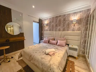 a bedroom with a large bed with pink pillows at AnfaSuites Casablanca - Les princesses - Cocon Urbain in Casablanca