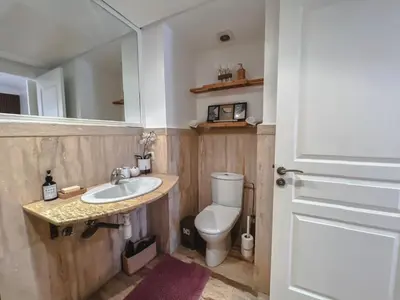 a bathroom with a toilet and a sink and a mirror at AnfaSuites Casablanca - Les princesses - Cocon Urbain in Casablanca