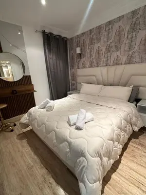 a bedroom with a large white bed with towels on it at AnfaSuites Casablanca - Les princesses - Cocon Urbain in Casablanca