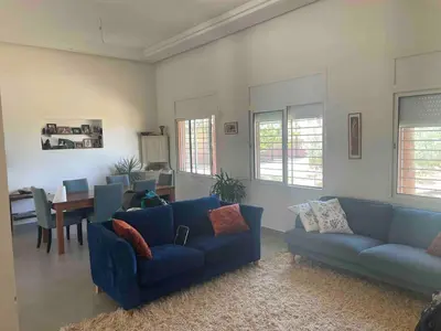 a living room with two blue couches and a table at premium farmhouse with pool Rabat in Rabat