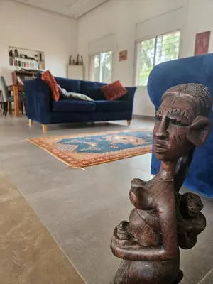 a statue of a child in a living room at premium farmhouse with pool Rabat in Rabat