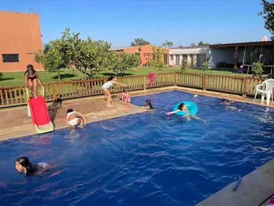 a group of people playing in a swimming pool at premium farmhouse with pool Rabat in Rabat