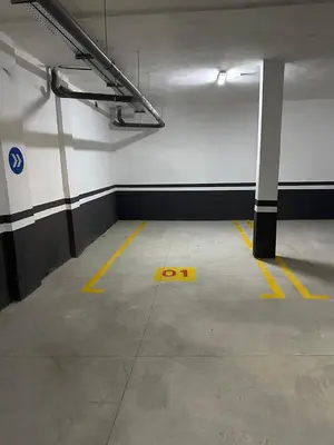 an empty parking garage with yellow lines on the floor at Cozy appartement luxueux in Mohammedia
