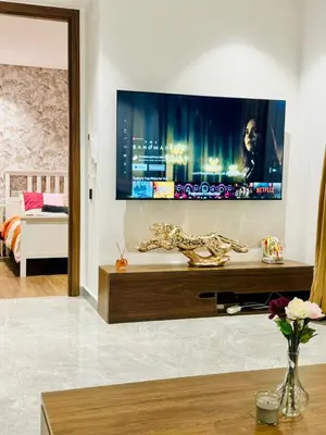 a living room with a flat screen tv on a wall at Chic Apartment in Casa Finance District -Open view - Fast WIFI in Casablanca