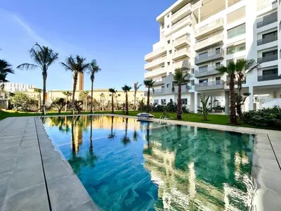 a swimming pool in front of a building at Chic Apartment in Casa Finance District -Open view - Fast WIFI in Casablanca