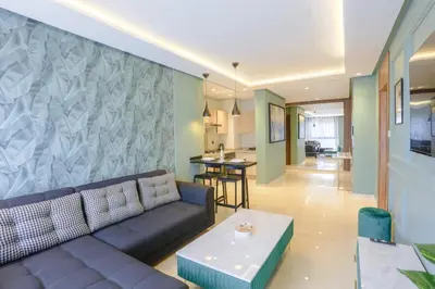 a living room with a couch and a table at Résidence Tour 33 - CFC district in Casablanca