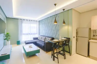 a living room with a couch and a table at Résidence Tour 33 - CFC district in Casablanca