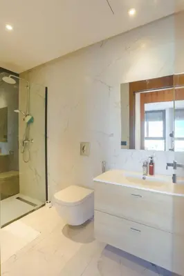 a bathroom with a toilet and a sink and a shower at Résidence Tour 33 - CFC district in Casablanca