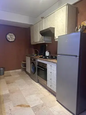 a kitchen with a white refrigerator and a stove at Studio au cœur du centre ville de Casablanca in Casablanca