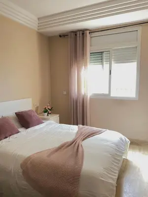 a bedroom with a large bed and a window at Chill by Sea-Relaxing Stay with a View in Rabat