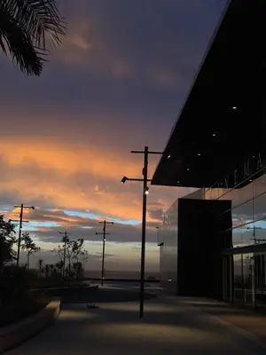 a street light in front of a building with a sunset at Chill by Sea-Relaxing Stay with a View in Rabat
