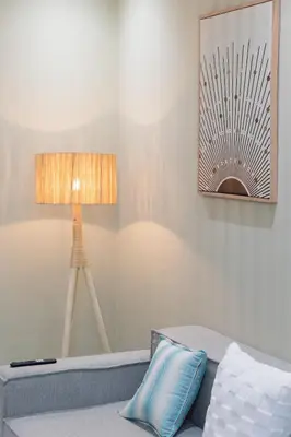 a lamp sitting next to a couch in a room at Modern & Chic APT Prestigia by MERAT HOME in Rabat