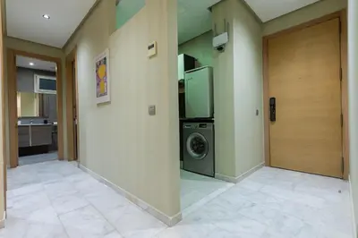 a laundry room with a washing machine and a door at Modern & Chic APT Prestigia by MERAT HOME in Rabat