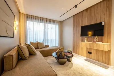 a living room with a couch and a tv at New - Cosy central Casablanca apartment in Casablanca