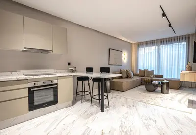 a kitchen and living room with a stove and a couch at New - Cosy central Casablanca apartment in Casablanca