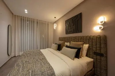 a bedroom with a large bed with pillows at New - Cosy central Casablanca apartment in Casablanca