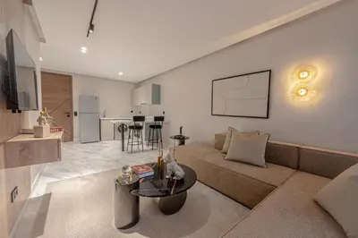 a living room with a couch and a table at New - Cosy central Casablanca apartment in Casablanca
